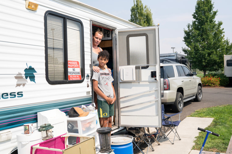  Stitt and Dante look on from their camper.
