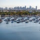 A drone view shows sailboats moored next to the Coconut Grove Sailing Club and the downtown skyline in Miami