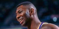 Elden Campbell of the Los Angeles Lakers smiles on the court.