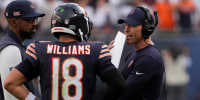 Sep 21, 2025; Chicago, Illinois, USA; Chicago Bears head coach Ben Johnson talks with quarterback Caleb Williams (18) against the Dallas Cowboys during the second half at Soldier Field. Mandatory Credit: David Banks-Imagn Images